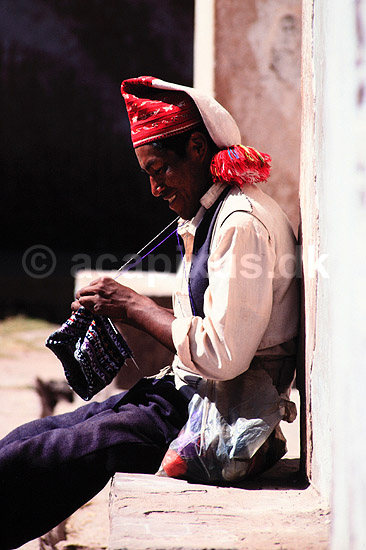 Strikkende mand. Strikkende mand p� �en Taquile p� Titicaca s�en ( Scan af KOL2046 ) ; ; Titicaca S�en; Peru; Sydamerika; ; h�ndv�rk, strikkehue